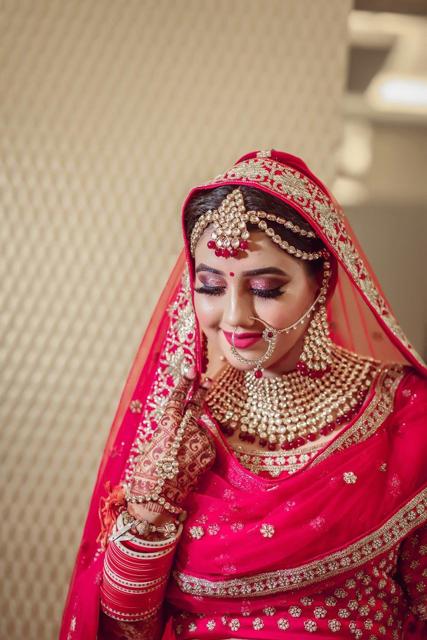 Bride in red and gold bridal lehenga