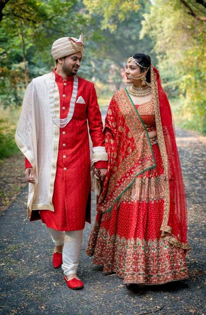 Bride and groom walking on a garden path