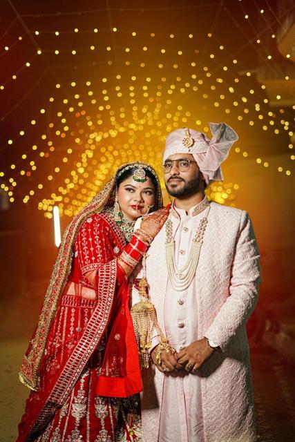 Bride and groom under fairy lights