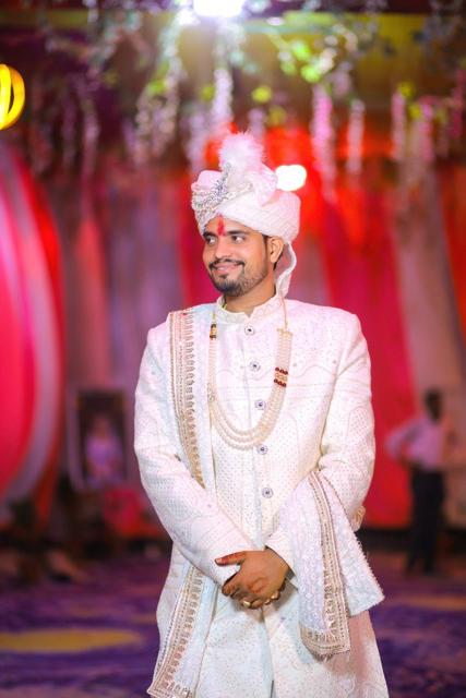 Groom in ivory sherwani and safa