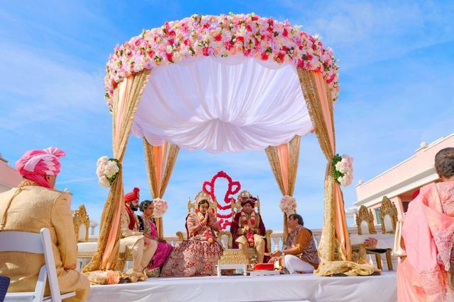 Floral mandap at an outdoor wedding